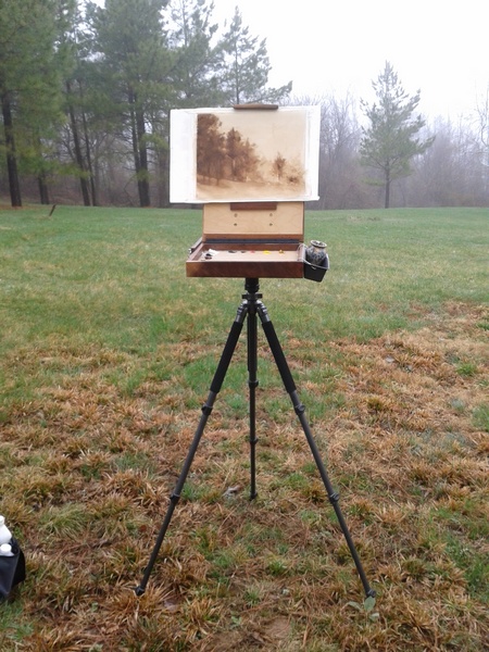 A home made pochade box on a carbon-fiber tripod.