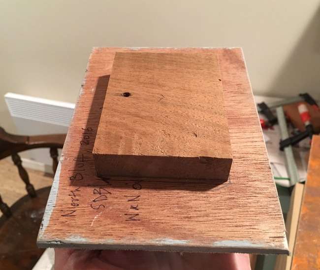 A wooden block attached to the back of a painting panel to offset from the wall