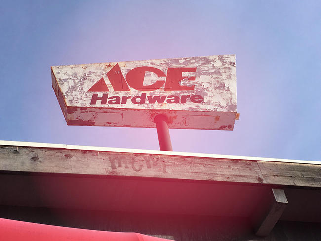 A photo of an old Ace Hardware sign with peeling paint