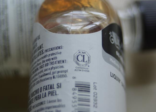 The ACMI Cautionary Label on a bottle of LIquin